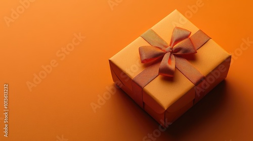 Orange gift box with bow. This photo is perfect for showcasing special occasions, celebrations, and gift-giving.