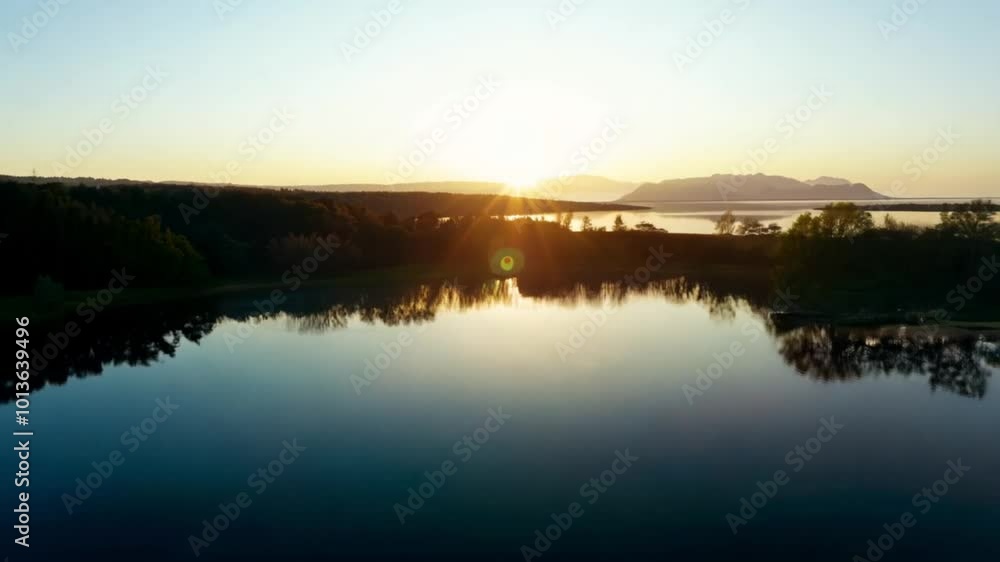 The wide shot featured a slow pan across the still water, capturing the reflections of the sunrise and evoking a sense of calmness. The wide shot featured a slow pan across the still water, capturing the reflections of the sunrise and evoking a sense of calmness.
