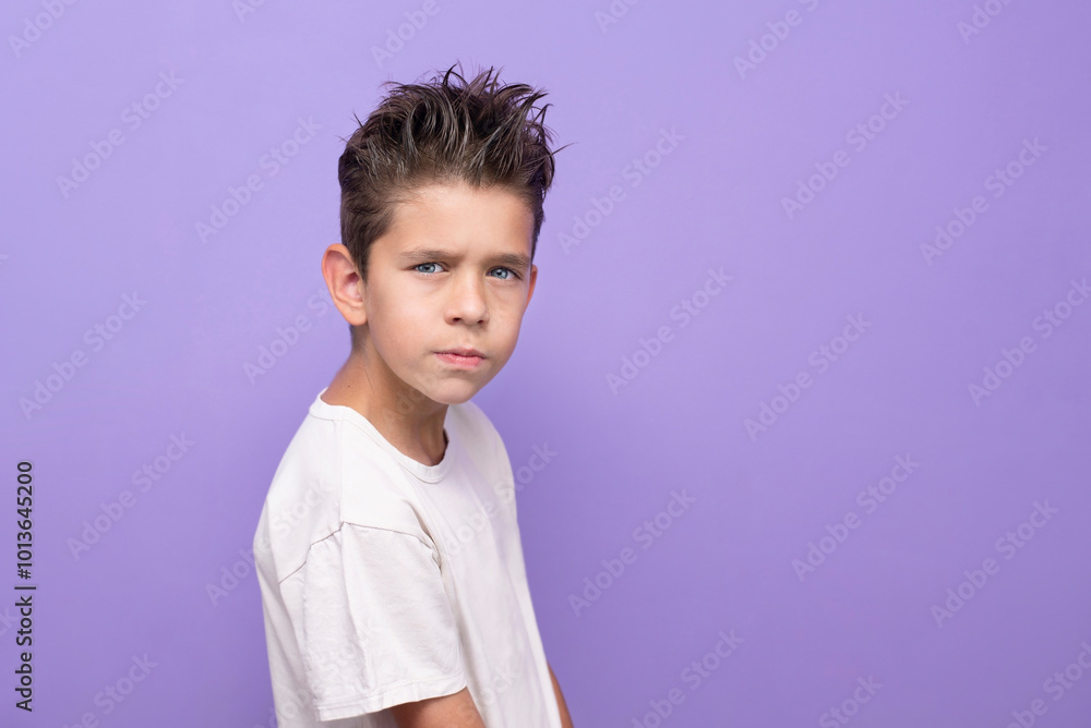 The boy has misunderstandings with friends and he sits at home, looking for himself, his identity through his external changes and communication with parents. Young boy has a nice hairstyle