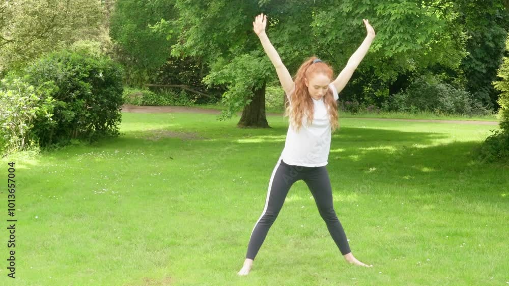 Embracing nature in a serene garden as a young woman flows through her mindful movements Embracing nature in a serene garden as a young woman flows through her mindful movements