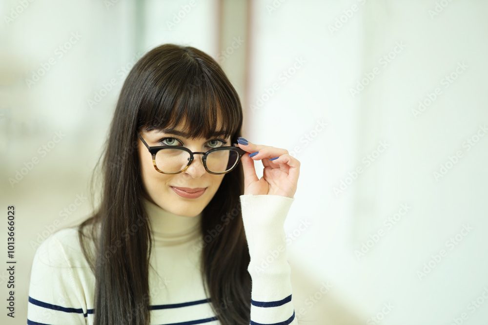 Lovely Caucasian modern girl is looking in camera over her glasses. Concept young girls lifestyle scenes Lovely Caucasian modern girl is looking in camera over her glasses. Concept young girls lifestyle scenes