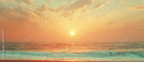 Sunset over the ocean with a beautiful orange sky and waves crashing on the beach.