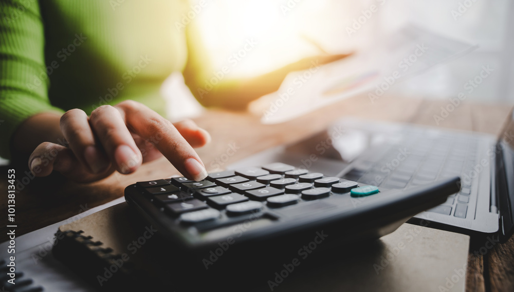 Close-up working in finance using tablet and calculator in modern office Prepare account analysis reports Real estate investment information Financial and tax system concepts Close-up working in finance using tablet and calculator in modern office Prepare account analysis reports Real estate investment information Financial and tax system concepts