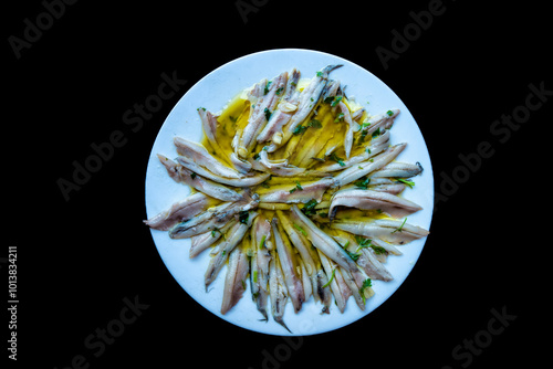 top view cenital of a tapa plate of boquerones en vinagre (pickled anchovies in vinegar)