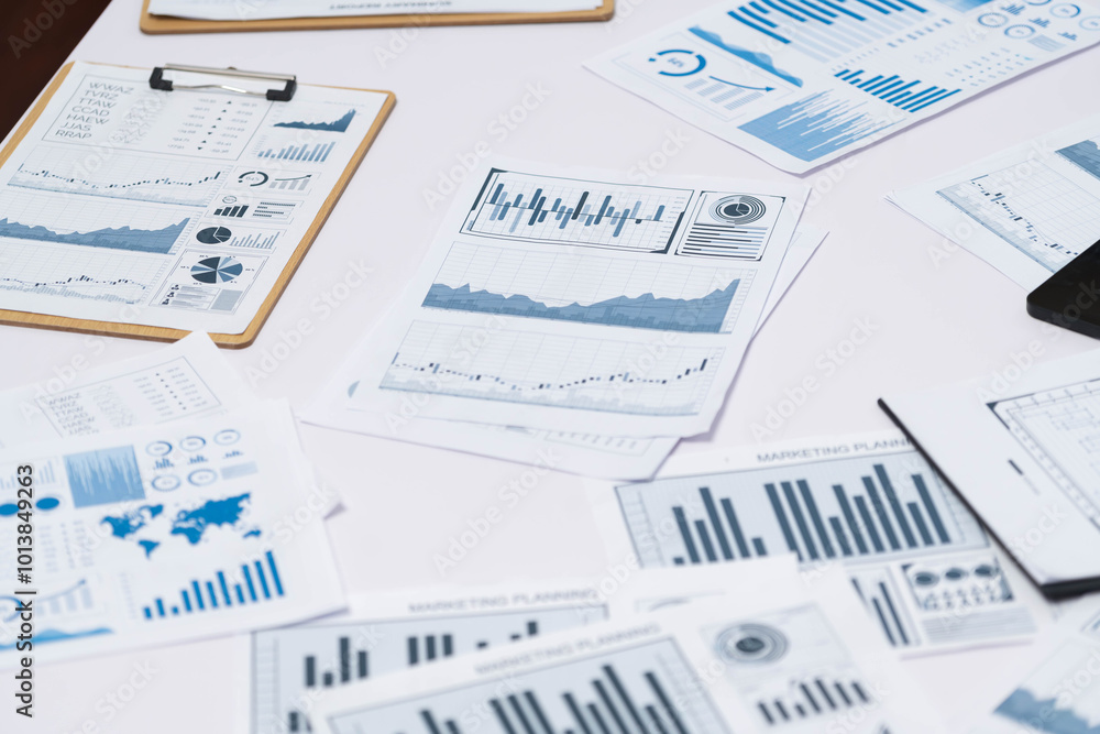 Piles of business intelligence paper or BI financial report and financial data visualization on paperwork for business analytic marketing and strategic planning at office desk. Prudent