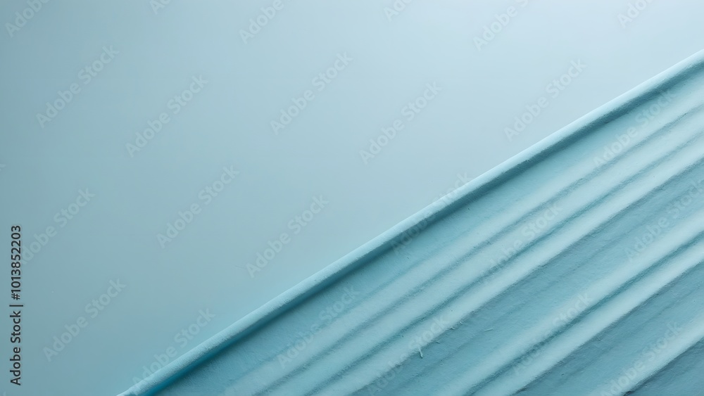 Obraz premium Soft Blue Fabric Draped Elegantly on a Neutral Background During a Serene Afternoon Light Setting
