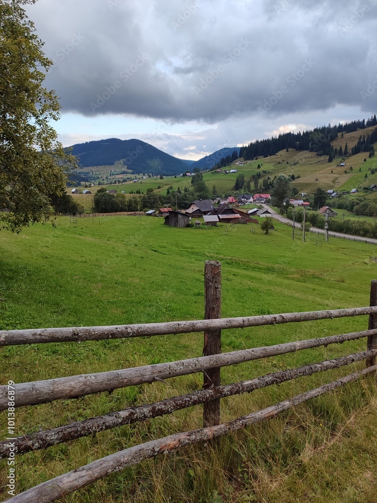 a view of the mountains and a green meadow
a view of the mountains and a green meadow