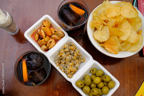 typical spanish aperitiv vermut before lunch with olives cockles mussels and chips photo