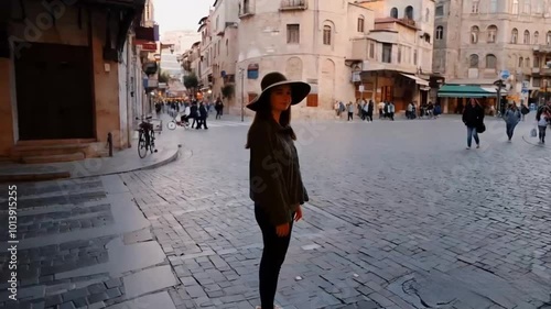 Happy tourist takes pictures while walking in an old part of city