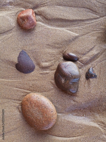 Pebbles in the sand at Legzira beach at the shore of the Atlantic Ocean, north of the town of Sidi Ifni, Southwest Morocco photo