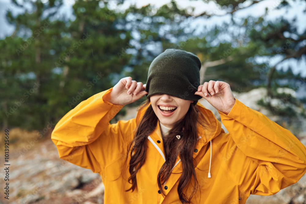 Woman in Yellow Raincoat and Hat with Hands on Head, Covering Eyes Fashionable Rainy Day Beauty Amidst Travel Adventures Woman in Yellow Raincoat and Hat with Hands on Head, Covering Eyes Fashionable Rainy Day Beauty Amidst Travel Adventures