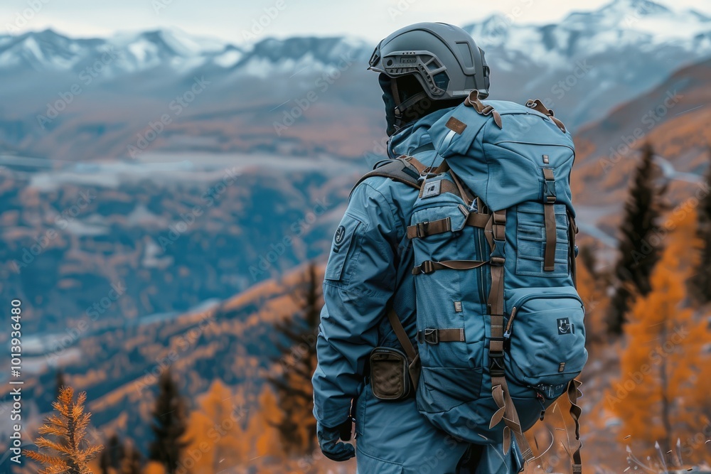 A Person in a Helmet and Backpack Looking Out Over Mountains A Person in a Helmet and Backpack Looking Out Over Mountains