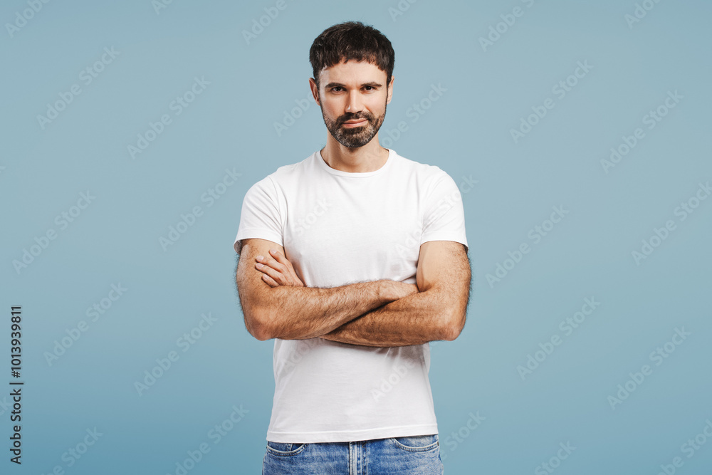 Confident, positive bearded man wearing white t shirt looking at camera with crossed arms Confident, positive bearded man wearing white t shirt looking at camera with crossed arms