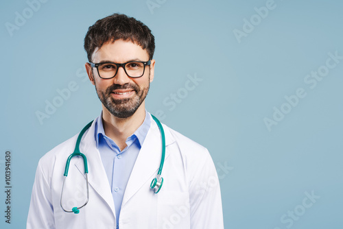 Portrait of smiling, attractive doctor with arms crossed wearing lab coat and stethoscope