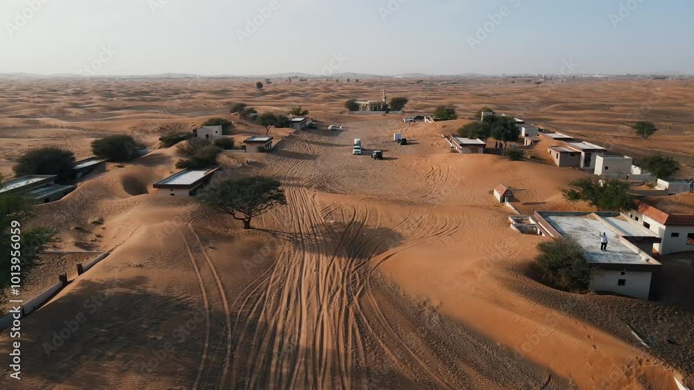Aerial view of abandoned houses in the UAE desert near Dubai, overtaken by sand dunes Aerial view of abandoned houses in the UAE desert near Dubai, overtaken by sand dunes