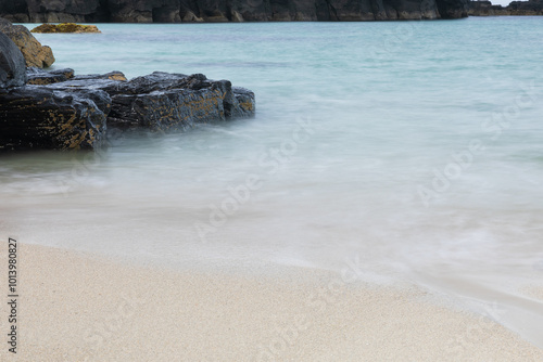 long exposure photo of a white sand beach with crystal clear and clean sea water in Scotland photo