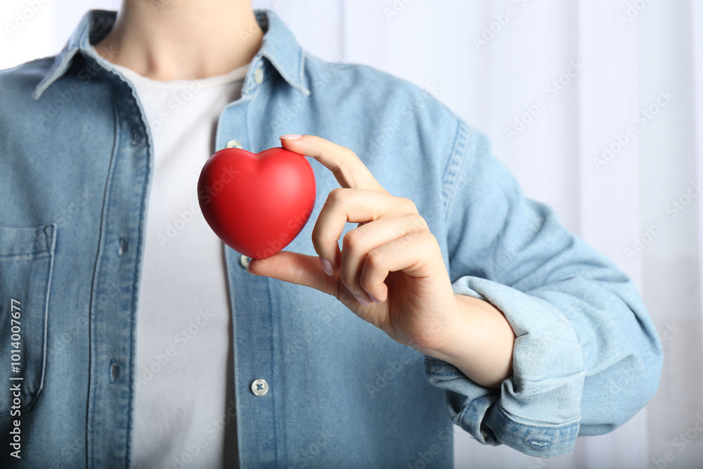 Woman holding red heart on light background, closeup Woman holding red heart on light background, closeup