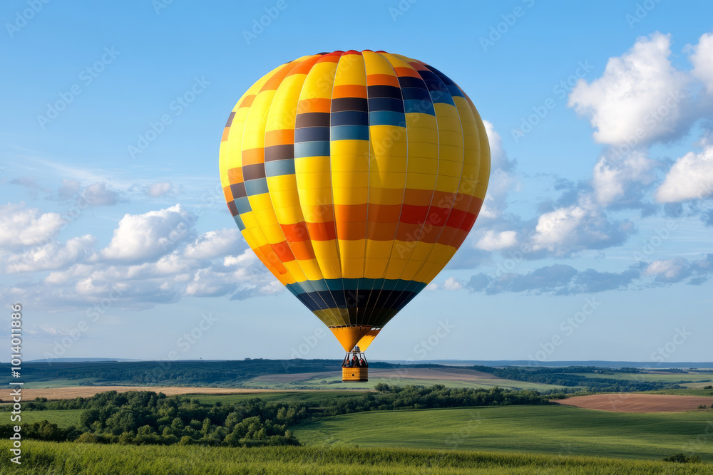 Obraz premium Hot air balloon floating in blue sky surrounded by soft clouds