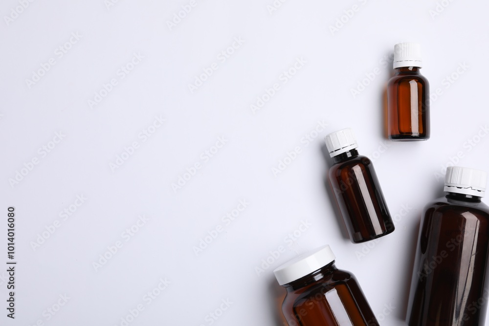 Medical bottles with medicine on white background, top view. Space for text Medical bottles with medicine on white background, top view. Space for text