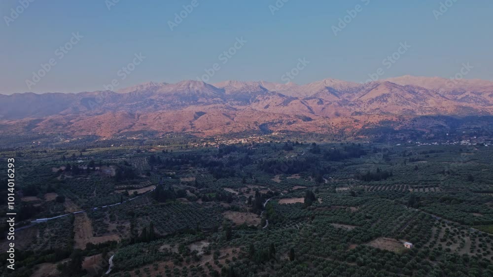 Expansive view of rolling hills and mountains at sunset in Greece Expansive view of rolling hills and mountains at sunset in Greece
