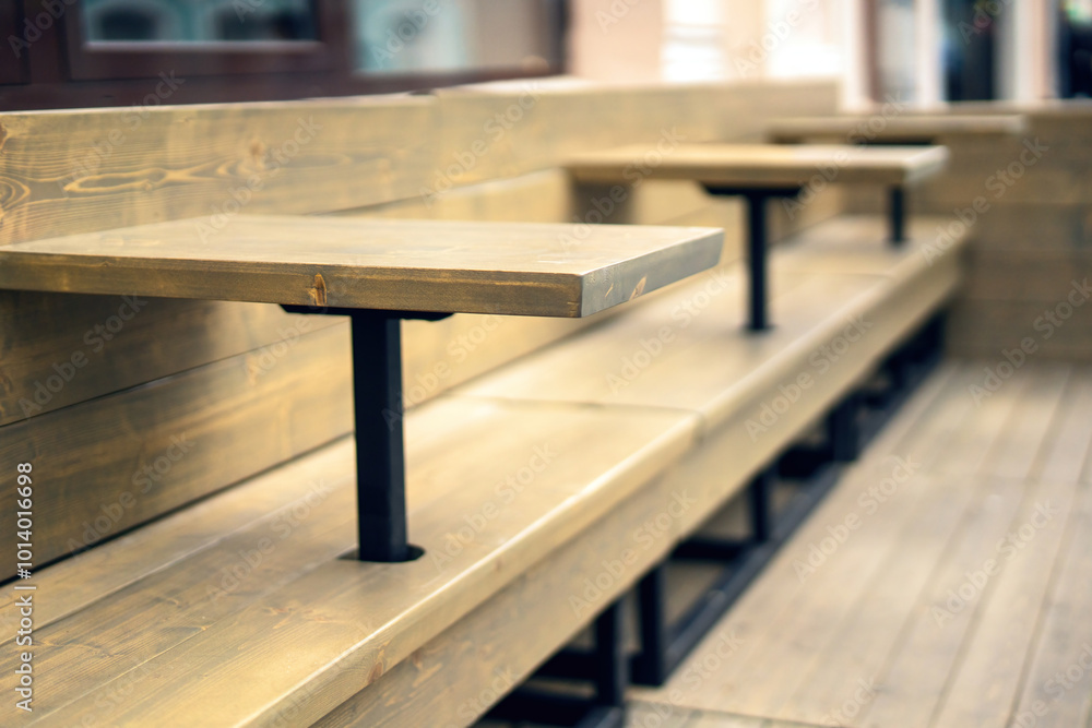wooden tables seamlessly integrated into a long bench at an outdoor restaurant, creating a harmonious blend of functionality and aesthetics in an inviting setting wooden tables seamlessly integrated into a long bench at an outdoor restaurant, creating a harmonious blend of functionality and aesthetics in an inviting setting