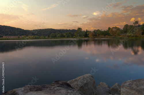 Tranquil Lakeside View with Sunset Reflections on Calm Water 