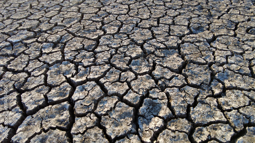 Obraz na płótnie broken and cracked lands caused by drought, lands split open by thirst, w salonie