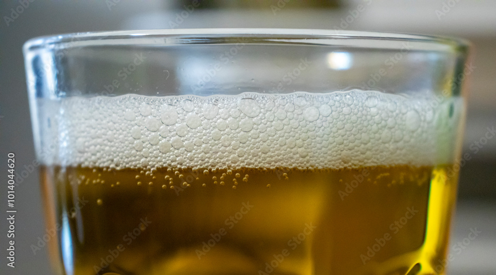 Close-up of a refreshing glass of beer with bubbles and foam, showcasing a golden liquid. Perfect for beverage-related concepts and summer enjoyment. Close-up of a refreshing glass of beer with bubbles and foam, showcasing a golden liquid. Perfect for beverage-related concepts and summer enjoyment.