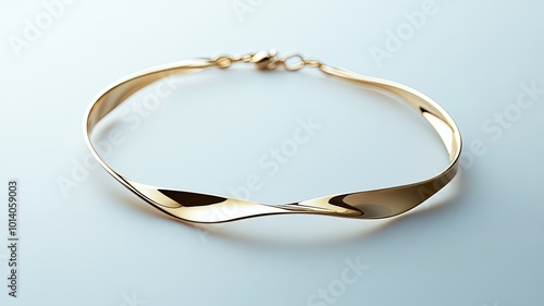 Wallpaper Mural Elegant gold bracelet featuring a unique twisted design on a soft blue background Torontodigital.ca