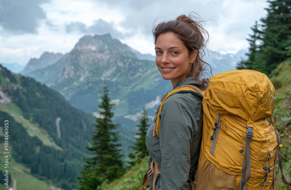 Woman with brown hair enjoying a hike in the stunning mountain landscape with a yellow backpack Woman with brown hair enjoying a hike in the stunning mountain landscape with a yellow backpack