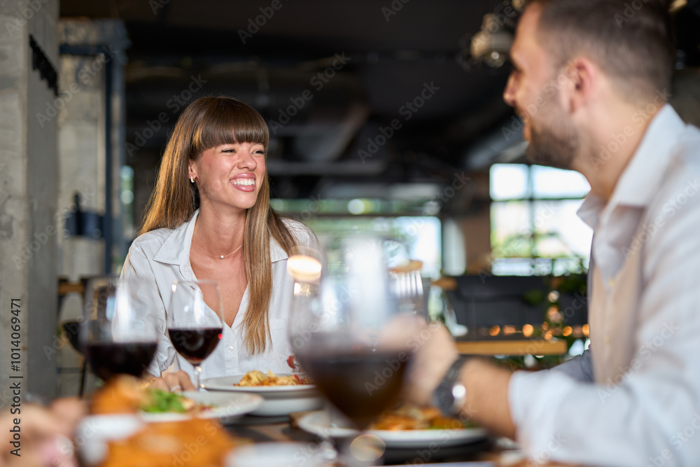 Happy business couple talking on a lunch in restaurant. Happy business couple talking on a lunch in restaurant.