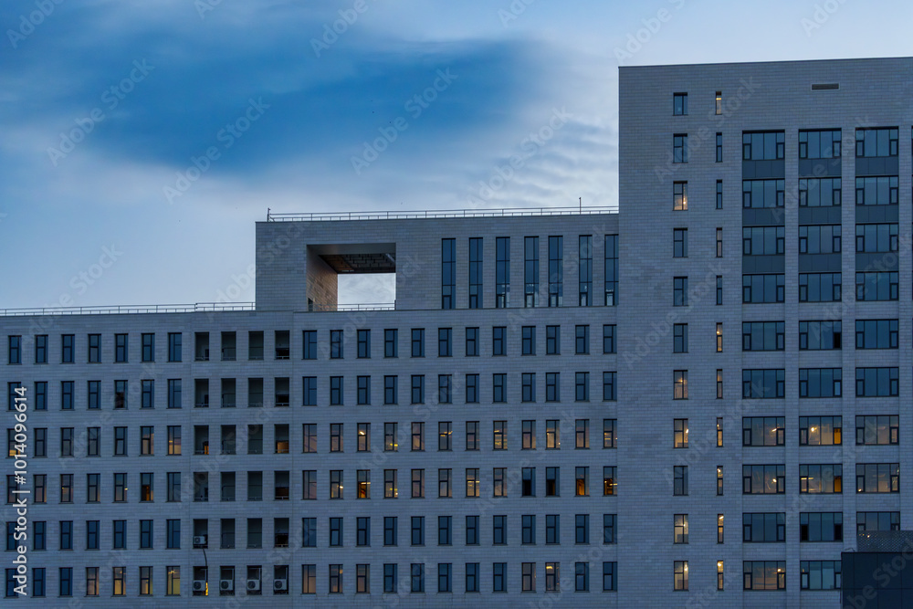 Modern office building exterior during twilight with geometric design Modern office building exterior during twilight with geometric design