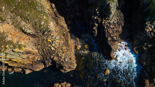 Aerial View of Rocky Coastline with Waves at Land's End, Cornwall, UK