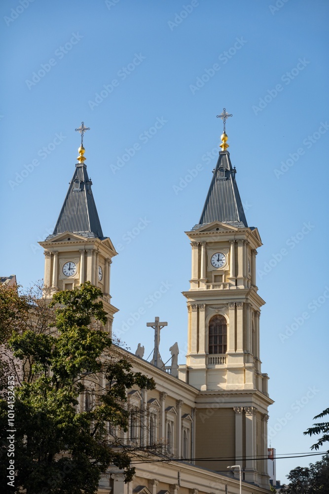 Fototapeta premium Two clock towers of Katedrala Bozskeho Spasitele cathedral in Ostrava, Czechia