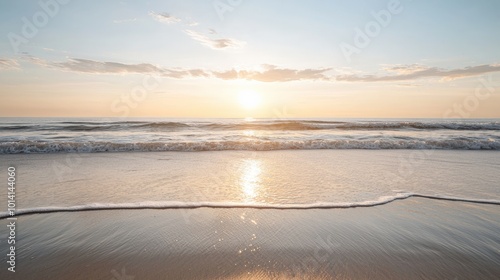 A serene sunset over the ocean, with gentle waves lapping at the shore, creating a peaceful atmosphere.