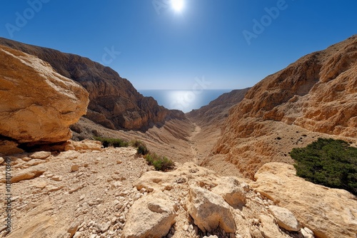 Hazy heat over a dry canyon landscape, with the sun beating down and the rocky terrain shimmering in the heat photo