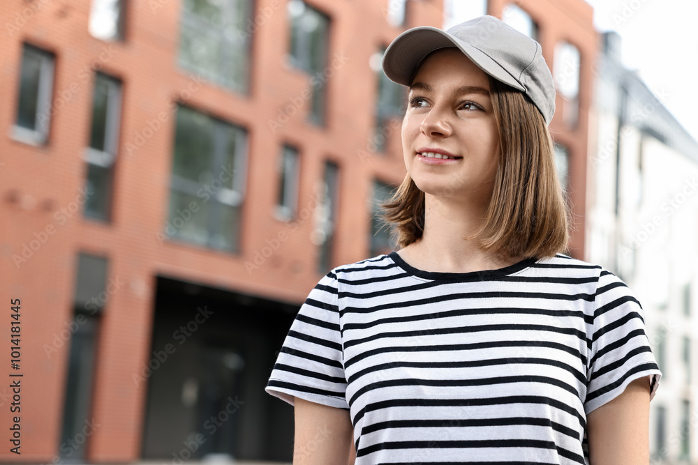 Portrait of smiling woman in baseball cap outdoors. Space for text Portrait of smiling woman in baseball cap outdoors. Space for text
