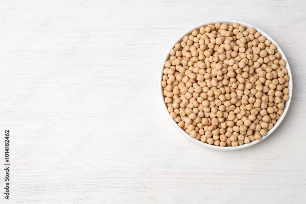Dried peas on light wooden table, top view. Space for text Dried peas on light wooden table, top view. Space for text
