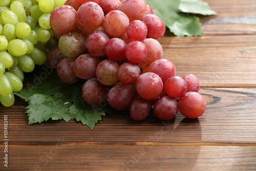 Fresh ripe grapes on wooden table, closeup