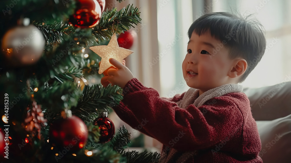 Asian boy placing star on Christmas tree, concept of holiday wonder Asian boy placing star on Christmas tree, concept of holiday wonder