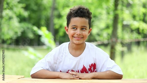 Little boy posing in a summer park