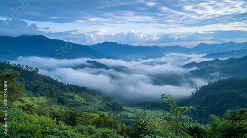 Morning mist blankets valleys in a serene mountainous region during dawn