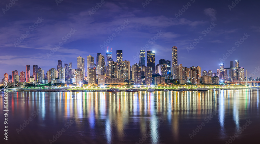 Panoramic view of city skyline and modern buildings scenery in Chongqing at night. Modern city buildings and water reflections. Panoramic view of city skyline and modern buildings scenery in Chongqing at night. Modern city buildings and water reflections.
