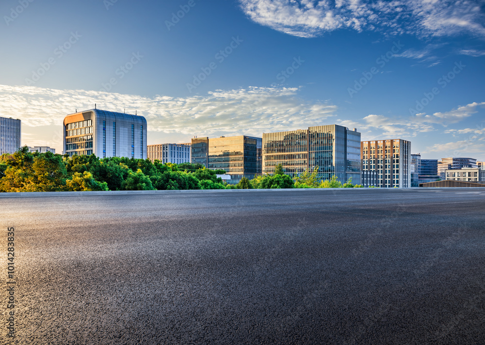Asphalt road with modern city buildings scenery at sunset. car advertising background.