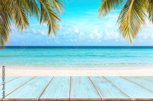 Empty light blue table overlooking tropical white sand beach