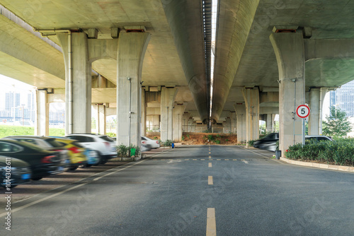 Concrete structure and asphalt road space under the overpass in the city