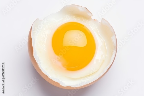 Top view of a perfectly cooked fried egg in a frying pan isolated on a clean white background