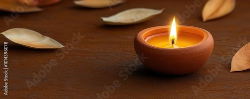 Warm Diwali candlelight glowing softly in a traditional clay diya, surrounded by festive decor, Diwali candle warmth, celebratory ambiance photo