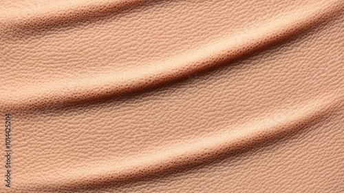 Close-up of textured peach fabric with soft folds.