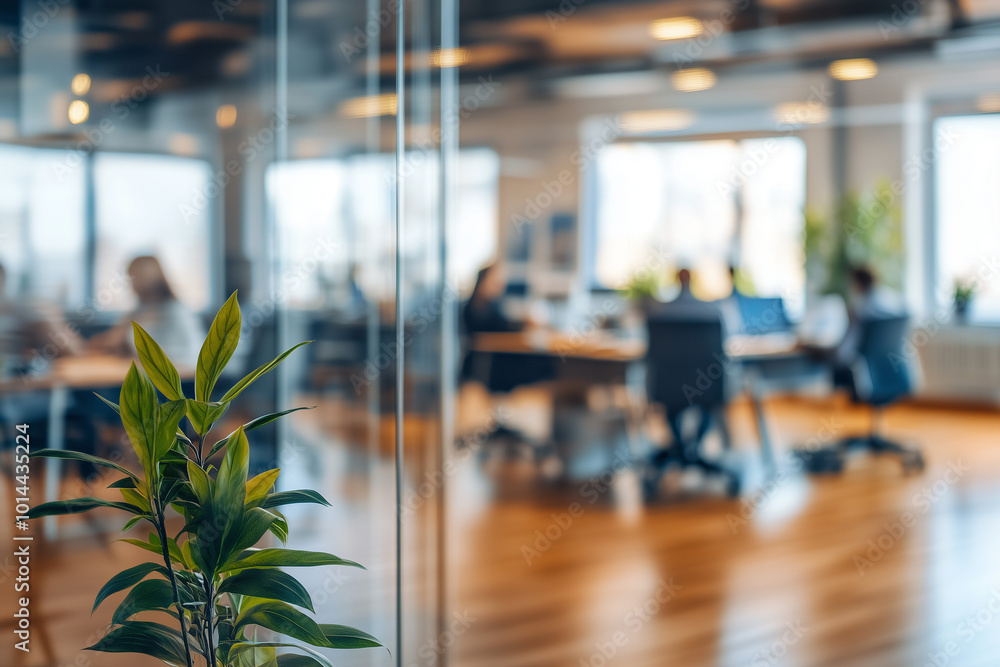 Blurred office environment with a glass wall, showing people working in the background, emphasizing a modern business setting Blurred office environment with a glass wall, showing people working in the background, emphasizing a modern business setting